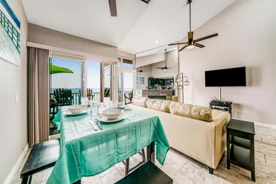 a living room with a couch and a table at Whitewater Village Charm in Oceanside