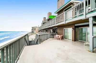 a balcony with a view of the beach at Whitewater Village Charm in Oceanside