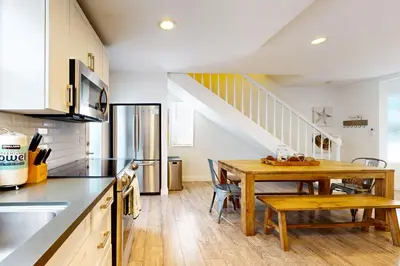 a kitchen with a wooden table and a dining room at La Jolla Beach Retreat in San Diego
