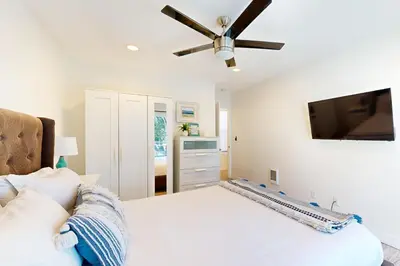 a bedroom with a bed and a ceiling fan at La Jolla Beach Retreat in San Diego