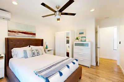 a bedroom with a bed and a ceiling fan at La Jolla Beach Retreat in San Diego