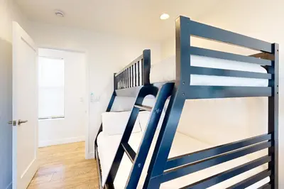 a blue bunk bed in a room with a window at La Jolla Beach Retreat in San Diego