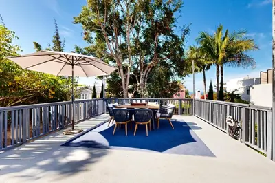 a patio with a table and chairs and an umbrella at La Jolla Beach Retreat in San Diego