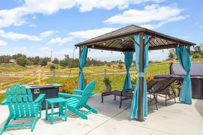 a patio with blue chairs and a gazebo at Gaia Inn & Spa- Adult Only- Temecula Wine Country in Temecula