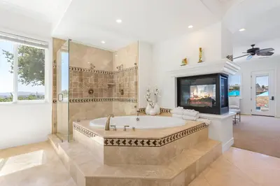 a large bathroom with a tub and a tv at Gaia Inn & Spa- Adult Only- Temecula Wine Country in Temecula