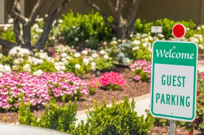 a guest parking sign in front of a flower garden at Gaia Inn & Spa- Adult Only- Temecula Wine Country in Temecula