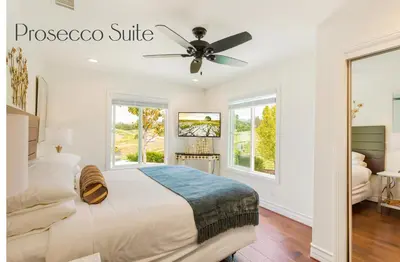 a bedroom with a bed and a ceiling fan at Gaia Inn & Spa- Adult Only- Temecula Wine Country in Temecula