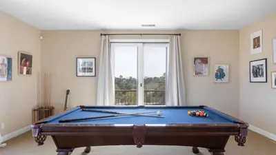 a room with a pool table in front of a window at Palazzo Del Sol By AvantStay Breathtaking Home w Mountain Views Hot Tub in Temecula