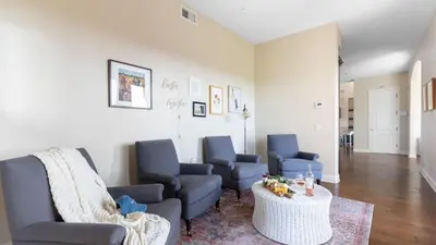 a living room with blue chairs and a table at Palazzo Del Sol By AvantStay Breathtaking Home w Mountain Views Hot Tub in Temecula