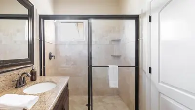 a bathroom with a shower and a sink at Palazzo Del Sol By AvantStay Breathtaking Home w Mountain Views Hot Tub in Temecula
