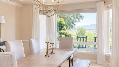 a dining room with a table and a large window at Grand Contento by AvantStay Extraordinary Estate w Pool Movie Room in Temecula