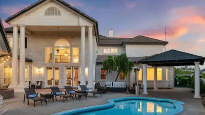 a house with a swimming pool in front of a house at Grand Contento by AvantStay Extraordinary Estate w Pool Movie Room in Temecula