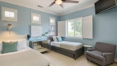 a bedroom with a bed and a chair and a window at Grand Contento by AvantStay Extraordinary Estate w Pool Movie Room in Temecula
