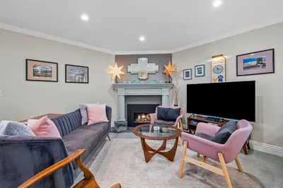 a living room with a couch and a tv and a fireplace at Sunsoak Shack in San Diego