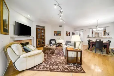a living room with white furniture and a fireplace at Ocean Pointe Getaway - 30-Night Minimum in Carlsbad