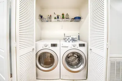a laundry room with a washer and dryer at Ocean Pointe Getaway - 30-Night Minimum in Carlsbad