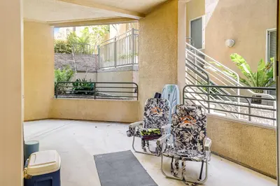 two chairs sitting on a porch with a balcony at Ocean Pointe Getaway - 30-Night Minimum in Carlsbad