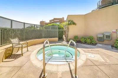 a small pool in a patio with a chair at Ocean Pointe Getaway - 30-Night Minimum in Carlsbad