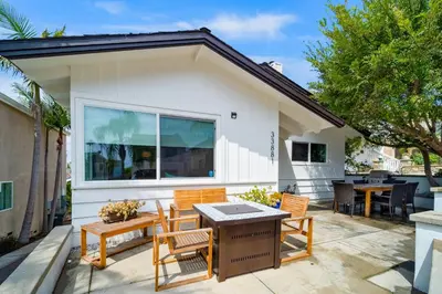a patio with two chairs and a table and a table and chairs at The Little Crab Shack in Dana Point