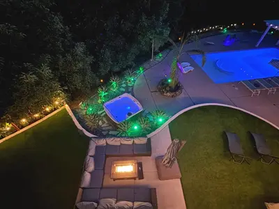 an overhead view of a swimming pool at night with lights at Hilltop Villa, Pool Oasis, Pickleball Court, Avocado Grove, Views in Fallbrook
