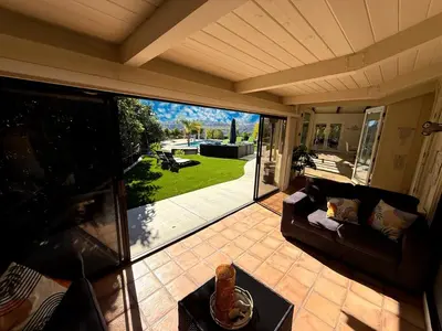a screened in porch with a couch and a patio at Hilltop Villa, Pool Oasis, Pickleball Court, Avocado Grove, Views in Fallbrook