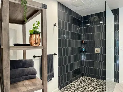 a bathroom with a shower with a glass door at Hilltop Villa, Pool Oasis, Pickleball Court, Avocado Grove, Views in Fallbrook