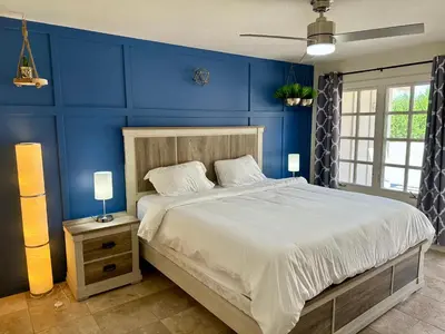 a bedroom with blue walls and a large bed at Hilltop Villa, Pool Oasis, Pickleball Court, Avocado Grove, Views in Fallbrook