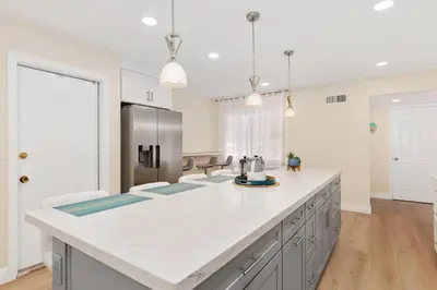 a kitchen with white countertops and a refrigerator at Golf - Beach - Legoland - Shopping - Dining in Carlsbad