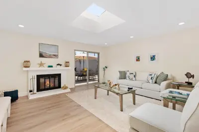 a living room with a couch and a fireplace at Golf - Beach - Legoland - Shopping - Dining in Carlsbad