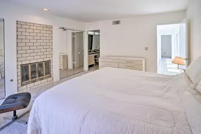 a white bedroom with a large bed and a bathroom at Unique Coto De Caza Home Near Hiking and Biking in Coto De Caza