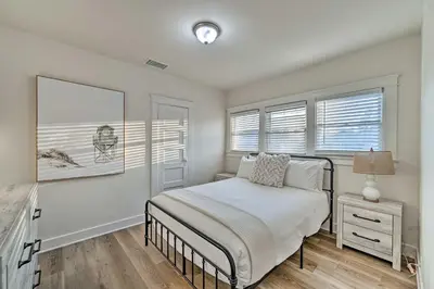 a white bedroom with a bed and two windows at Walk to Poway Farmers Market Family Retreat! in Poway