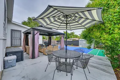 a patio with a table and chairs and an umbrella at Walk to Poway Farmers Market Family Retreat! in Poway
