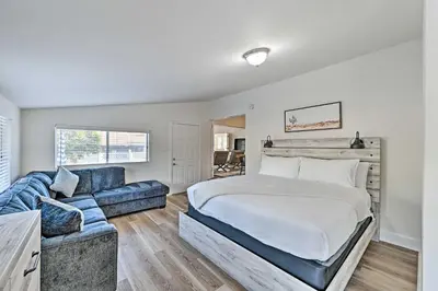 a bedroom with a bed and a blue couch at Walk to Poway Farmers Market Family Retreat! in Poway