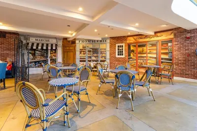 a restaurant with tables and chairs and a brick wall at Inn at Churon Winery in Temecula