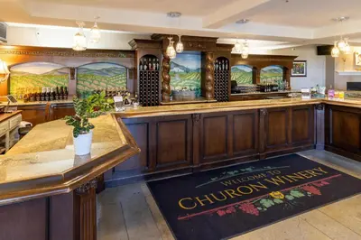 a bar in a pub with a sign on the floor at Inn at Churon Winery in Temecula