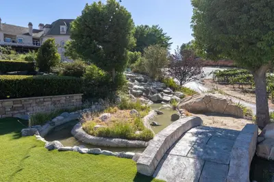 a garden with two dogs sitting in the grass at Inn at Churon Winery in Temecula