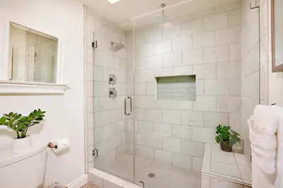 a white bathroom with a shower with a glass door at Fantastic Ocean View Remodeled All New Furnishings Pet Friendly AC in Oceanside