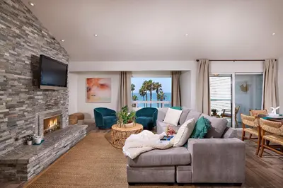 a living room with a couch and a fireplace at Fantastic Ocean View Remodeled All New Furnishings Pet Friendly AC in Oceanside