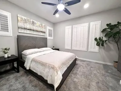a bedroom with a bed and a ceiling fan at San Diego Luxury Oasis in Spring Valley