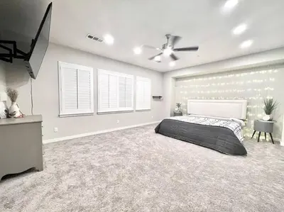 a bedroom with a bed and a ceiling fan at San Diego Luxury Oasis in Spring Valley