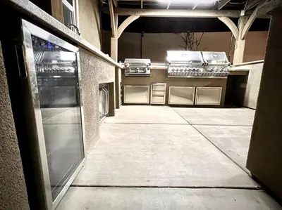 an empty kitchen with stainless steel appliances in a building at San Diego Luxury Oasis in Spring Valley