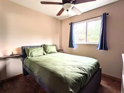 a bedroom with a bed with a ceiling fan at The Luminous Lodge-Remodeled Cabin W/ Valley Views in Santa Ysabel