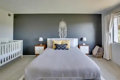 a bedroom with a large bed and a blue wall at La Mesa Townhome 15 Mi to San Diego! in La Mesa