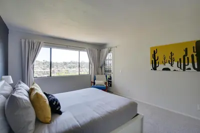 a bedroom with a bed and a large window at La Mesa Townhome 15 Mi to San Diego! in La Mesa