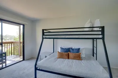 a bedroom with a bunk bed with blue and white pillows at La Mesa Townhome 15 Mi to San Diego! in La Mesa