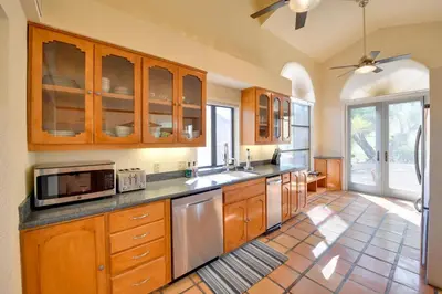 a kitchen with wooden cabinets and a microwave at Pet-Friendly Borrego Springs Retreat in Borrego Springs