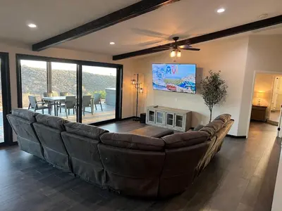 a living room with a large couch and a table at Winery Getaway with Spa and Amazing Hilltop View in Temecula