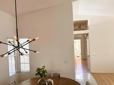 a dining room with a table and a chandelier at Silver Sands Den in Hemet