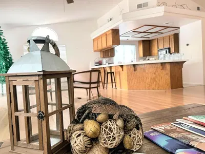 a kitchen and living room with a table with a lantern at Silver Sands Den in Hemet