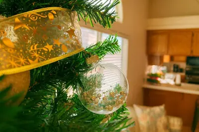 a christmas tree with a glass ornament on it at Starlight Western Room in Hemet
